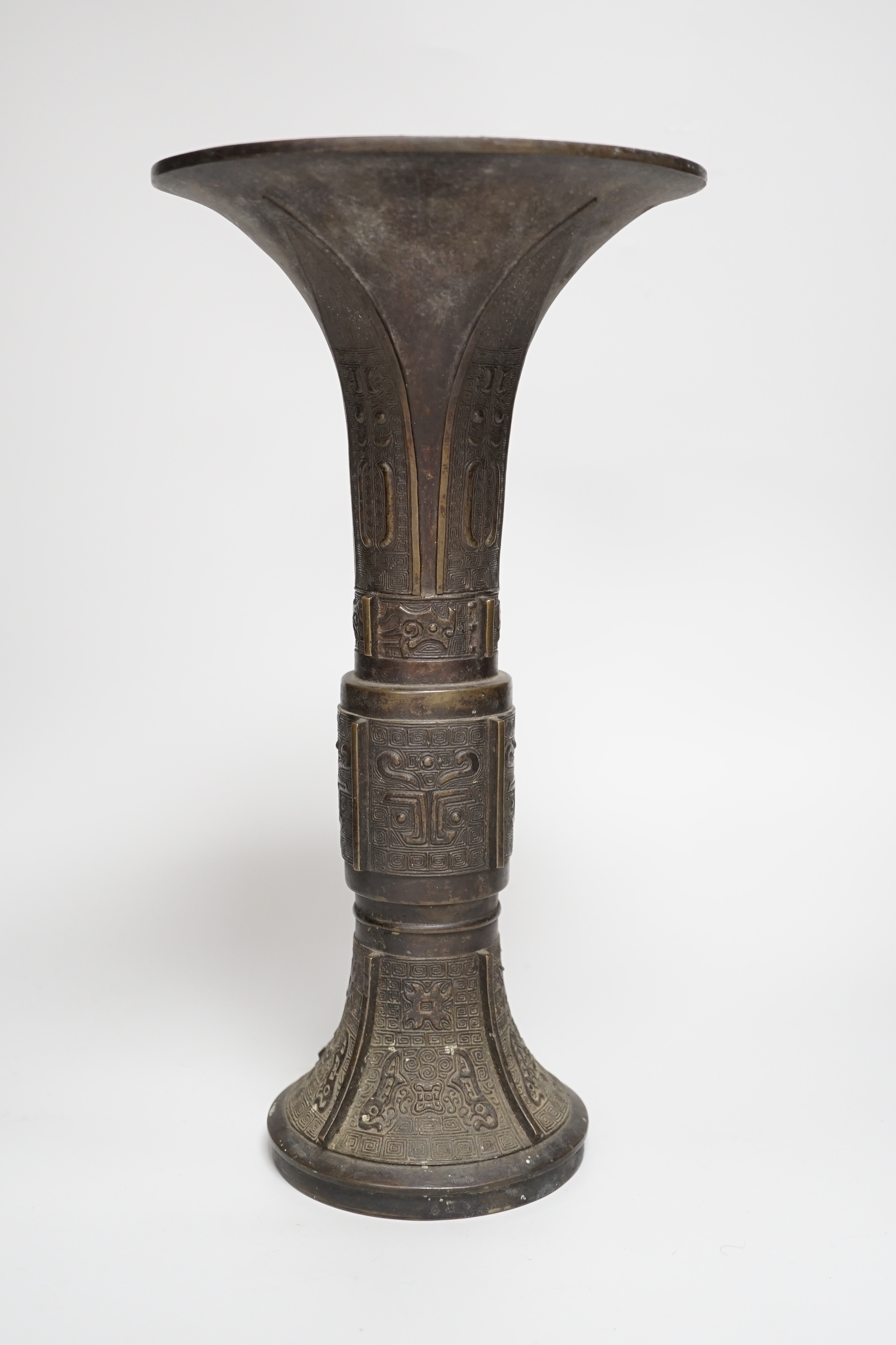 An 18th/19th century Chinese archaistic bronze beaker vase, gu, 34cm high
